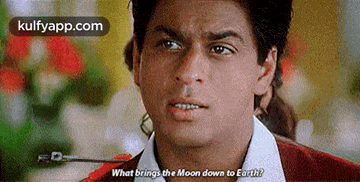 a man is talking to another man and asking what brings the moon down to earth .