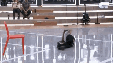 a person is laying on their stomach on a dance floor