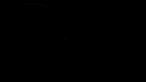 a close up of a man and a woman 's faces in a dark room