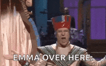 a man in a pharaoh costume is standing in front of a purple curtain .