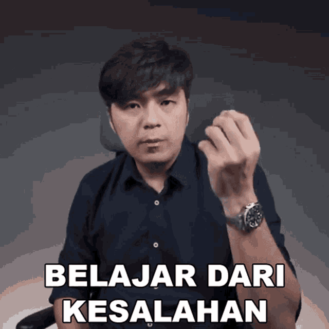 a man wearing a watch says belajar dari kesalahan in a foreign language