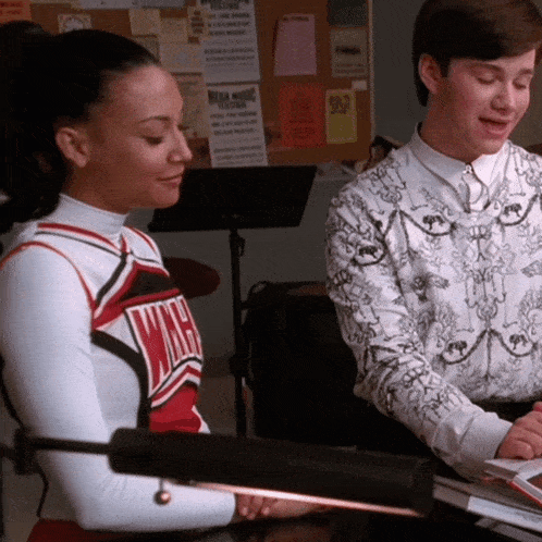 a cheerleader wearing a red white and black sweater with the word wmhs on it