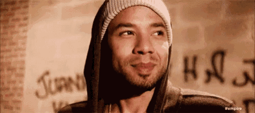a man wearing a beanie and a hoodie is smiling .
