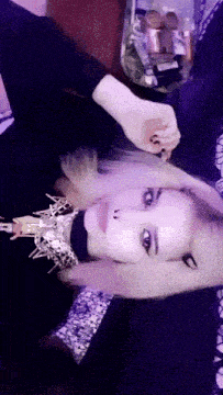 a woman wearing a choker is laying on her back