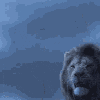 a lion with its mouth wide open against a blue sky