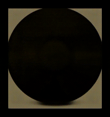 a blurry picture of a person 's face is surrounded by a black circle