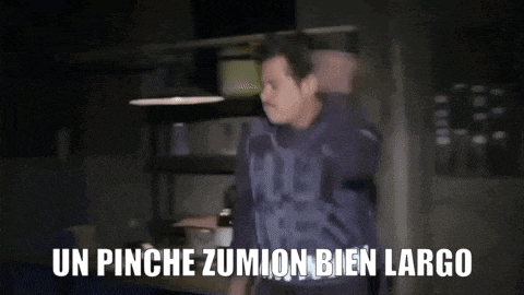 a man is standing in a dark room with the words un pinche zumion bien largo
