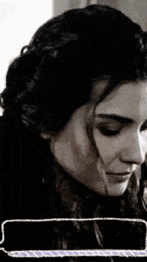 a close up of a woman 's face with a speech bubble in the corner .
