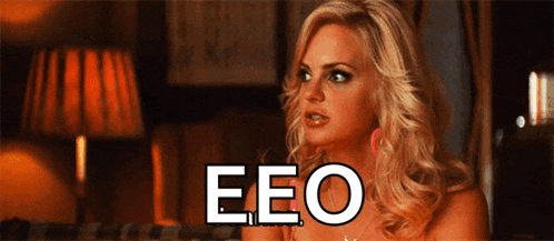 a blonde woman with the word eeo written in white letters