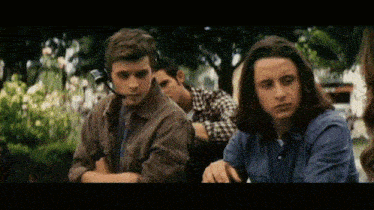 a man wearing a headset sits next to a woman