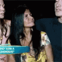 a woman in a yellow shirt is sitting next to a man