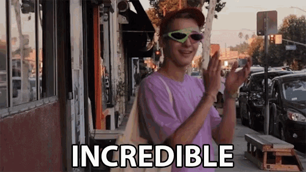 a man wearing sunglasses and a purple shirt says incredible on the street