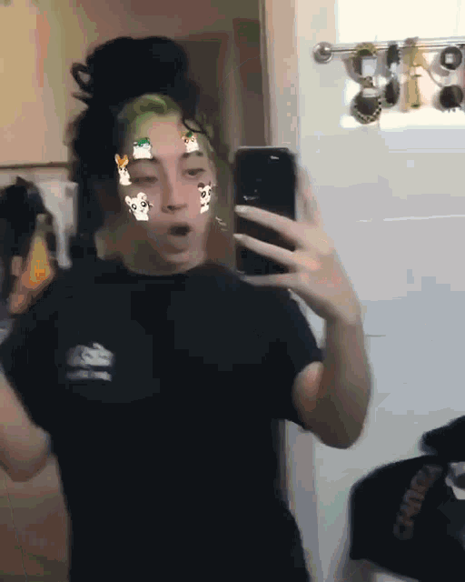 a person is taking a selfie in front of a mirror with stickers on their face