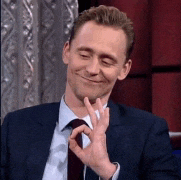 a man in a suit and tie is giving a thumbs up sign