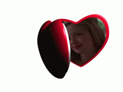 a heart shaped mirror with a picture of a woman