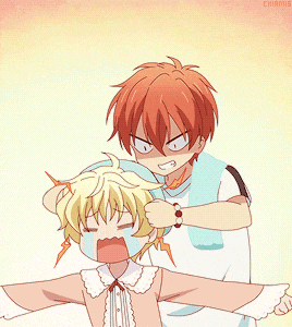 a boy with red hair is putting a towel on a girl with blonde hair
