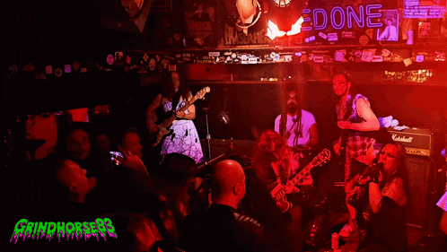 a group of people are playing instruments in front of a sign that says " edone "