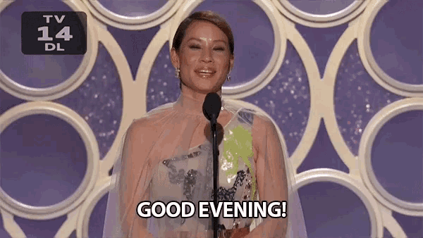 a woman stands in front of a microphone with the words good evening on her face
