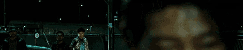 a close up of a person 's face with a blurry background of lights