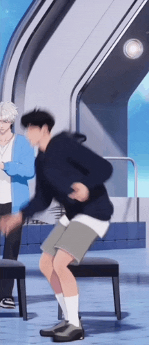 a man in a blue hoodie and shorts is dancing in front of a chair .