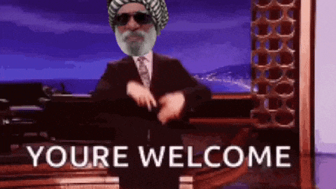 a man in a suit and tie is dancing in front of a sign that says you 're welcome