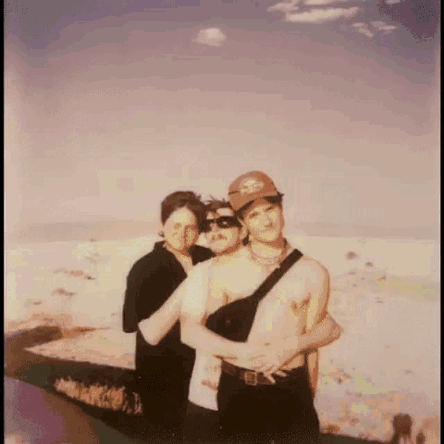 a group of people are posing for a picture in the desert