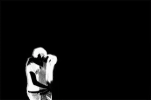 a man and a woman are kissing in front of hearts