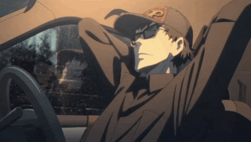 a man in a hat with the letter p on it sits in a car