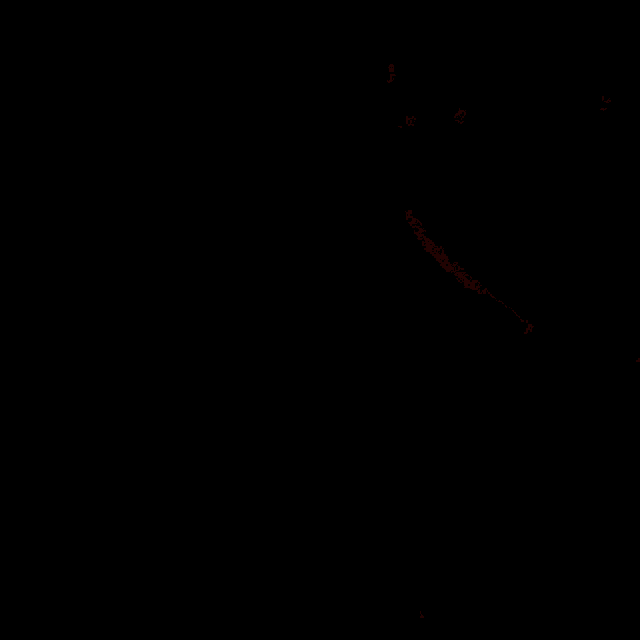 a close up of a doll 's face in a dark room with a red light behind her .