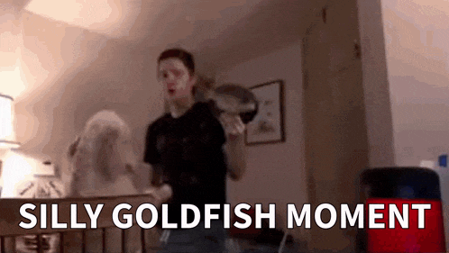 a man is standing in a crib holding a fish in his hand .