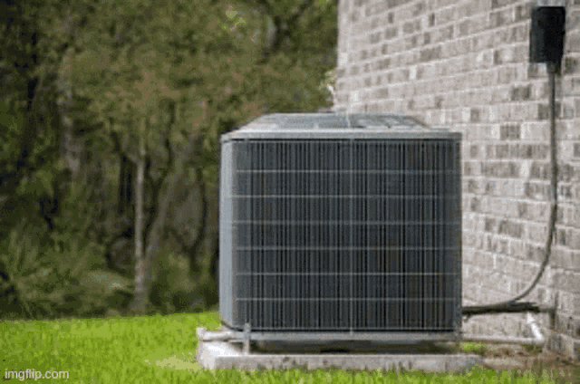 an air conditioner is sitting on the side of a house