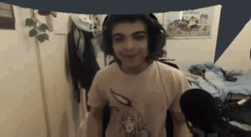 a young man wearing headphones and a t-shirt with a picture of a dog on it