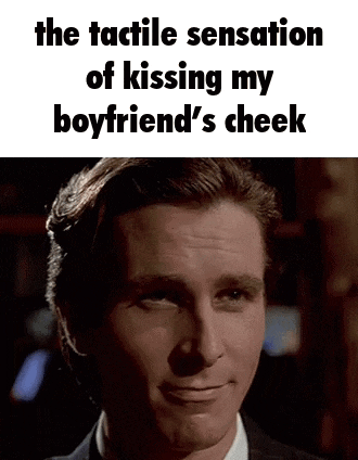 a man in a suit and tie is smiling with the caption `` the tactile sensation of kissing my boyfriend 's cheek ''