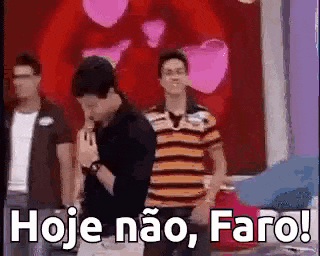 a group of men are standing next to each other in front of a red heart and a sign that says hoje não faro