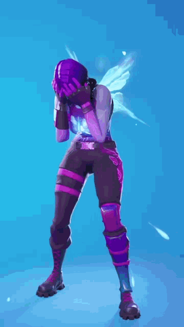 a woman in a purple and pink outfit is covering her face with her hands