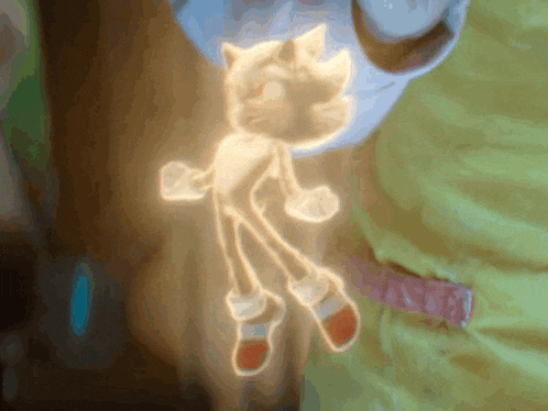 a glowing sonic the hedgehog is being held in someone 's hand
