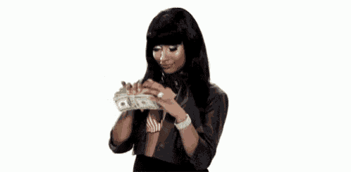 a woman in a leather jacket is holding a pile of money .