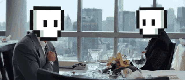 a man and a woman are sitting at a table with pixelated skulls on their faces