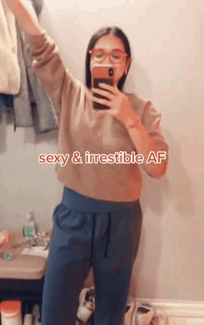 a woman taking a picture of herself with the words sexy and irresistible af