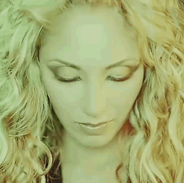 a close up of a woman 's face with a serious look on her face