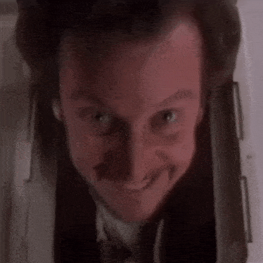 a close up of a man 's face with a slight smile on his face