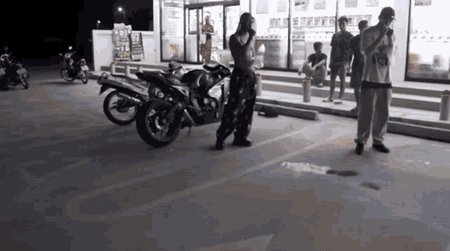 a group of people are standing in a parking lot with motorcycles parked in front of a 7 eleven store