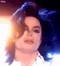 a close up of a person 's face with blue hair .