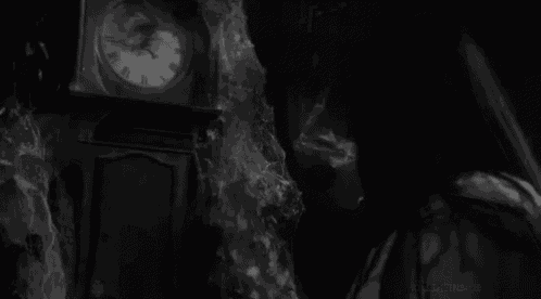 a black and white photo of a clock that has roman numerals
