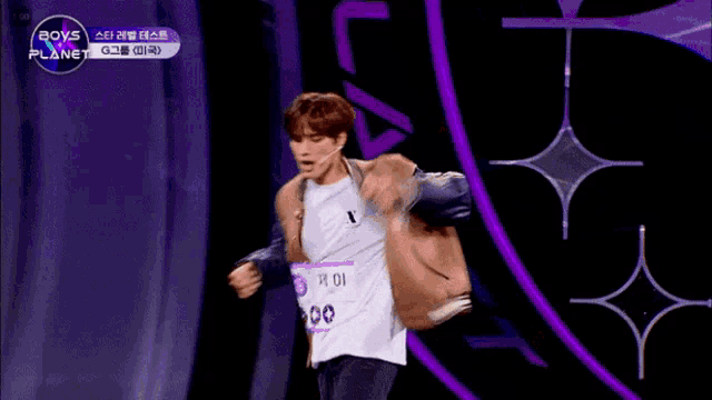 a man in a varsity jacket is on a boys planet show