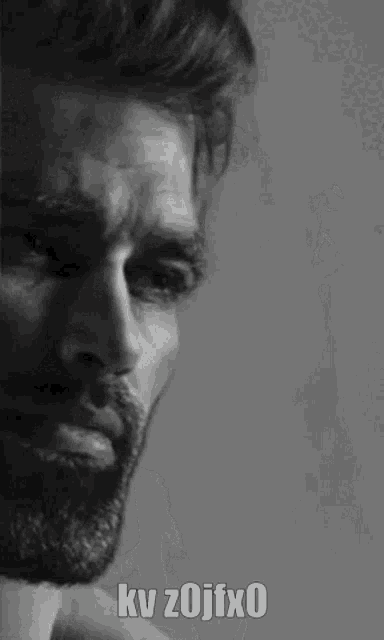 a black and white photo of a man with a beard and the words kv zojfx0 on his face .