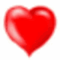 a red heart on a white background with a blurred background .