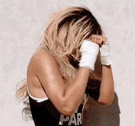 a woman wearing boxing gloves and a black shirt that says par