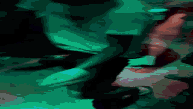 a blurry picture of a person in a dark room with blue lights behind them