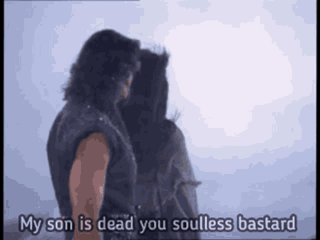a man standing next to a woman with the words " my son is dead you soulless bastard " written below him